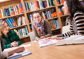 UB counseling students discuss at a table